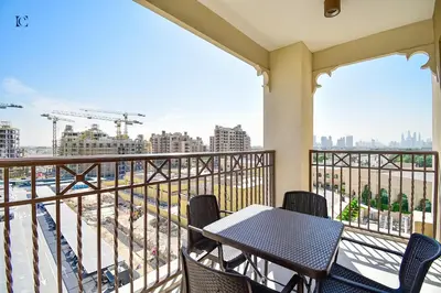 a balcony with a table and chairs at Luxury Escapes - Contemporary 2BR Gem in Madinat Jumeirah - RAHAAL in Dubai