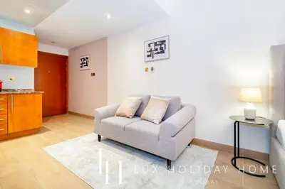a living room with a couch and a table at LUX The Marina View Suite 2 in Dubai