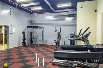 a gym with cardio equipment in a room at LUX The Marina View Suite 2 in Dubai