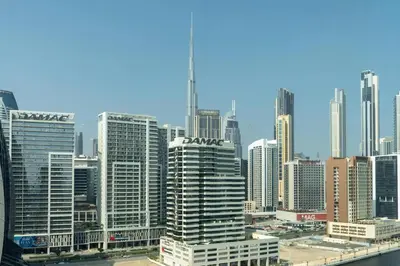 a view of a large city with tall buildings at Studio with Burj Khalifa View in Dubai