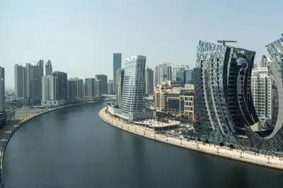 a view of a city with a river and buildings at Studio with Burj Khalifa View in Dubai