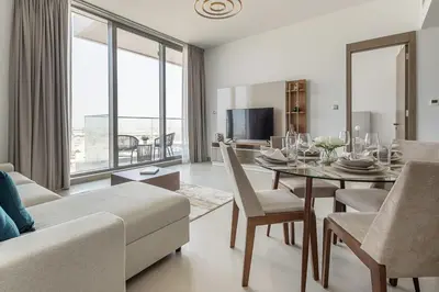 a living room with a dining room table and a couch at Frank Porter - Bluebell Residence in Dubai