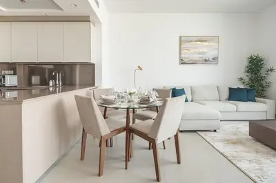 a kitchen and living room with a table and chairs at Frank Porter - Bluebell Residence in Dubai