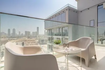 a balcony with a table and chairs and a view at Frank Porter - Bluebell Residence JVC in Dubai