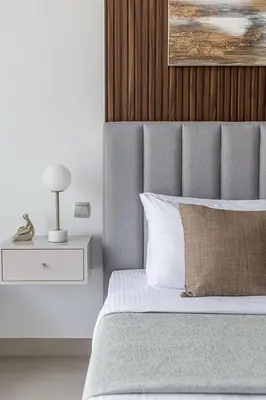 a bedroom with a bed and a lamp on a nightstand at Frank Porter - Bluebell Residence JVC in Dubai