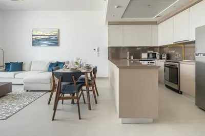 a kitchen and living room with a table and chairs at Frank Porter - Bluebell Residence JVC in Dubai