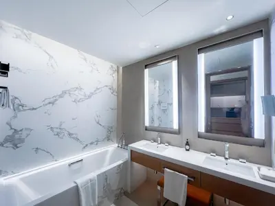 a bathroom with a tub and two sinks and a bath tub at #37 Luxury - 2BR in The Address Dubai Opera - Downtown in Dubai