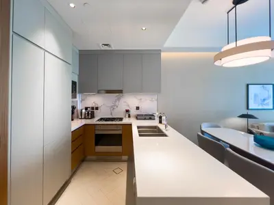 a kitchen with white cabinets and a counter top at #37 Luxury - 2BR in The Address Dubai Opera - Downtown in Dubai