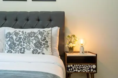 a bedroom with a bed and a nightstand with a lamp at White Sage- Damac Vera Residences 417 in Dubai