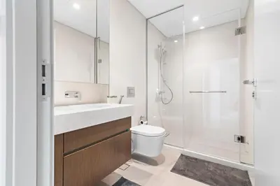 a bathroom with a sink and a toilet and a shower at StoneTree - Luxurious with Private Beach Access in Dubai