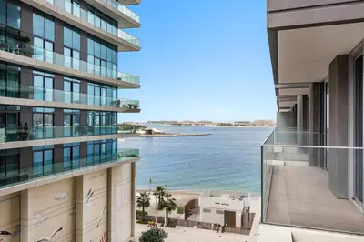 a view of the ocean from the balcony of a building at StoneTree - Luxurious with Private Beach Access in Dubai