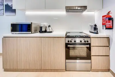 a kitchen with a microwave and a stove at Beautiful 1 bedroom in Port De La Mer in Dubai
