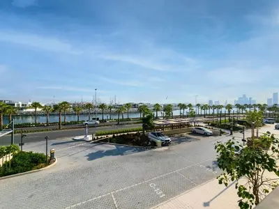 an empty parking lot with cars parked in it at Beautiful 1 bedroom in Port De La Mer in Dubai
