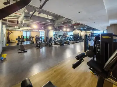 a gym with lots of treadmills and exercise bikes at Beautiful 1 bedroom in Port De La Mer in Dubai