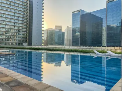 a swimming pool with a city skyline in the background at GuestReady - Vibrant Retreat in Dubai's Heart in Dubai