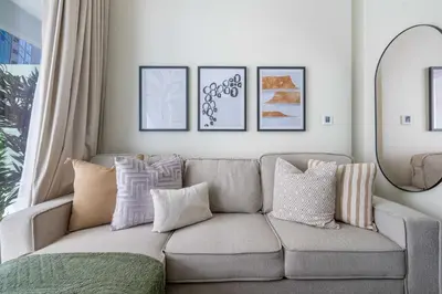 a living room with a gray couch with pillows at GuestReady - Vibrant Retreat in Dubai's Heart in Dubai