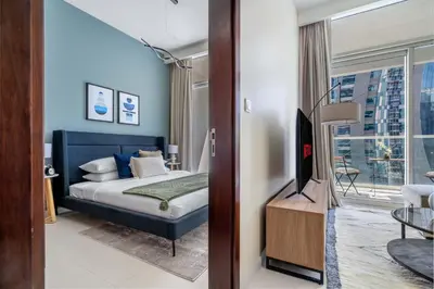 a hotel room with a bed and a tv at GuestReady - Vibrant Retreat in Dubai's Heart in Dubai