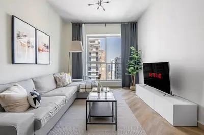 a living room with a couch and a tv at GuestReady Holiday Homes - Urban Elegance in JLT in Dubai