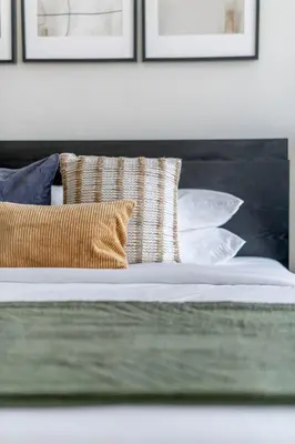 a close up of a bed with pillows on it at GuestReady Holiday Homes - Urban Elegance in JLT in Dubai