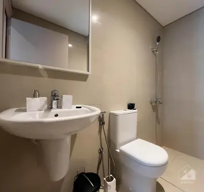 a bathroom with a sink and a toilet and a mirror at Luxury Burj Royale Apt Balcony Burj Khalifa View in Dubai