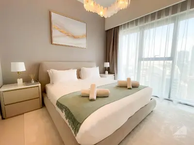 a bedroom with a large bed with two pillows on it at Burj Royale Luxury 1B Balcony & City View Downtown in Dubai