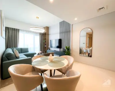 a living room with a table and chairs and a couch at Burj Royale Luxury 1B Balcony & City View Downtown in Dubai