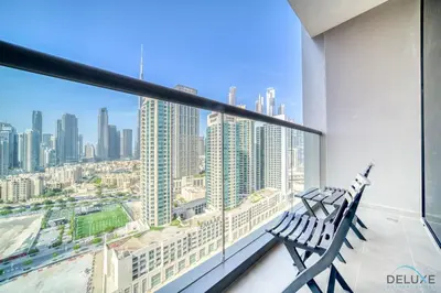 a balcony with two benches and a view of a city at Plush Studio at The Sterling East House Business Bay by Deluxe Holiday Homes in Dubai