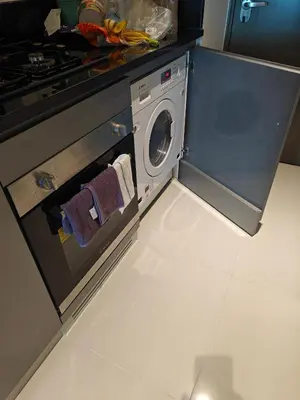 a kitchen with an oven with a washing machine at LeModCasa - Luxury smart Studio with Canal View Business Bay in Dubai