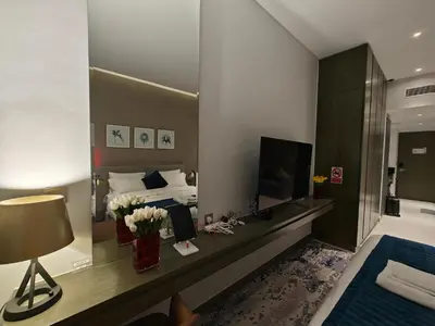 a hotel room with a bed and a mirror at LeModCasa - Luxury smart Studio with Canal View Business Bay in Dubai