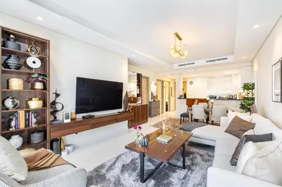 a living room with white furniture and a flat screen tv at Stylish 2BR at Paramount Hotel Midtown in Dubai