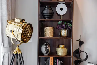 a book shelf with various items on it at Stylish 2BR at Paramount Hotel Midtown in Dubai