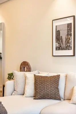 a living room with a white couch with pillows at Stylish 2BR at Paramount Hotel Midtown in Dubai