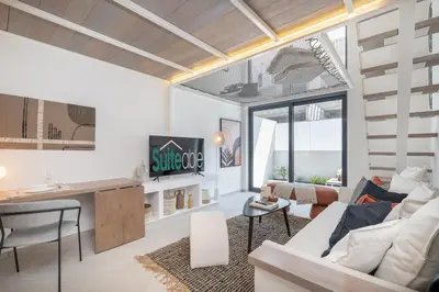 a living room with a couch and a table at Fashionable loft with catamaran net in JVC in Dubai