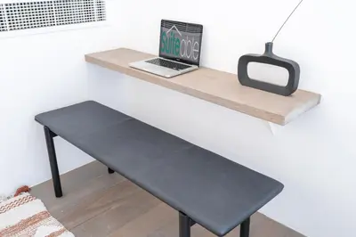 a desk with a laptop on a wall at Fashionable loft with catamaran net in JVC in Dubai