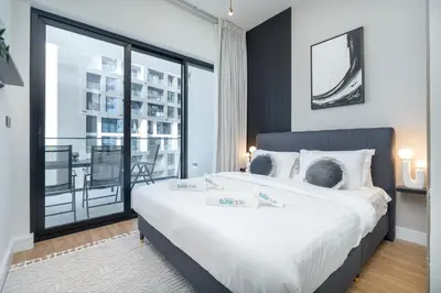 a bedroom with a large bed and a large window at Elegant treat with Burj Khalifa view by Suiteable in Dubai