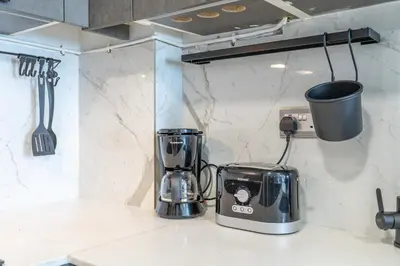 a kitchen with a toaster and a blender on a counter at Modern Comfort in a Spacious Apartment - Suiteable in Dubai
