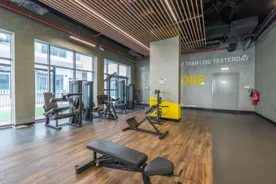 a gym with treadmills and exercise equipment in a building at Modern Comfort in a Spacious Apartment - Suiteable in Dubai