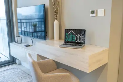 a desk with a laptop and a chair on it at Serenity in Style in Zada Residence by Suiteable in Dubai