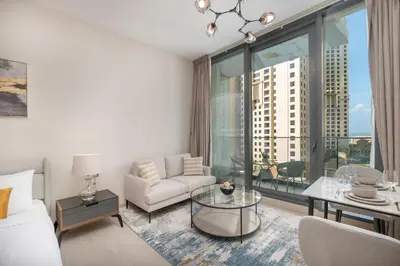 a living room with a couch and a glass table at Dive into Luxury at LIV Residence - Suiteable in Dubai