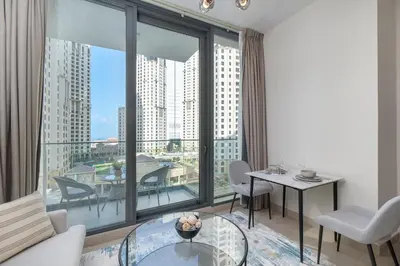 a living room with a large window with a table and chairs at Dive into Luxury at LIV Residence - Suiteable in Dubai