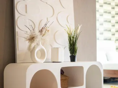 a white side table with vases and plants on it at Downtown Chic Easy walk to Dubai Mall & Fountain in Dubai