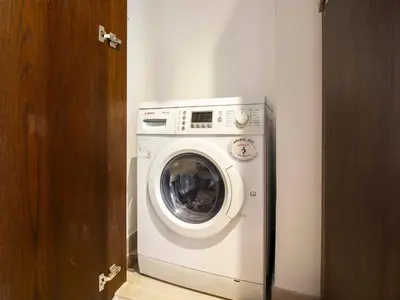 a white washer and dryer in a room at Downtown Chic Easy walk to Dubai Mall & Fountain in Dubai