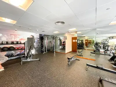 a gym with treadmills and machines in a room at Downtown Chic Easy walk to Dubai Mall & Fountain in Dubai