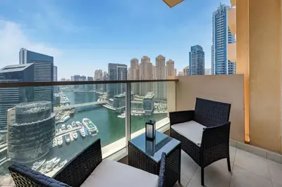 a balcony with two chairs and a table at Luxury Studio with Stunning Marina & Beach Views in Dubai