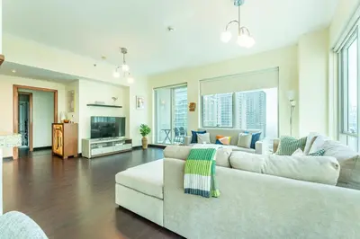 a living room with a couch and a tv at Dubai Marina Apartment with Sea view, Pool and Gym in Dubai