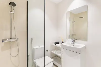 a bathroom with a shower and a toilet and a sink at Tranquil Dubai Marina Studio by JBR Beach, Marina Mall, Metro in Dubai