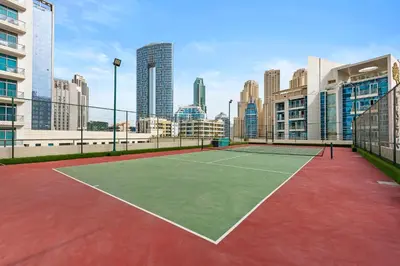 a tennis court in the middle of a city at Tranquil Dubai Marina Studio by JBR Beach, Marina Mall, Metro in Dubai