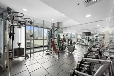 a gym with treadmills and machines in a building at Tranquil Dubai Marina Studio by JBR Beach, Marina Mall, Metro in Dubai