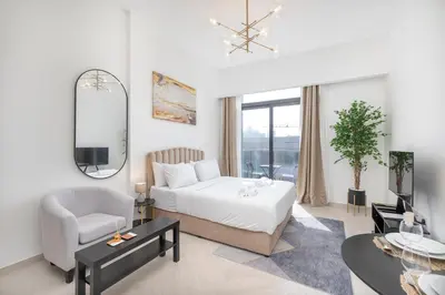 a bedroom with a bed and a chair and a mirror at New Listing - TOP Amenities in JVC in Dubai