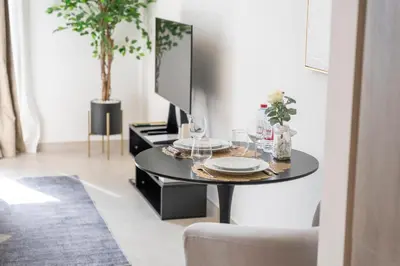 a black table with wine glasses and a tv on it at New Listing - TOP Amenities in JVC in Dubai